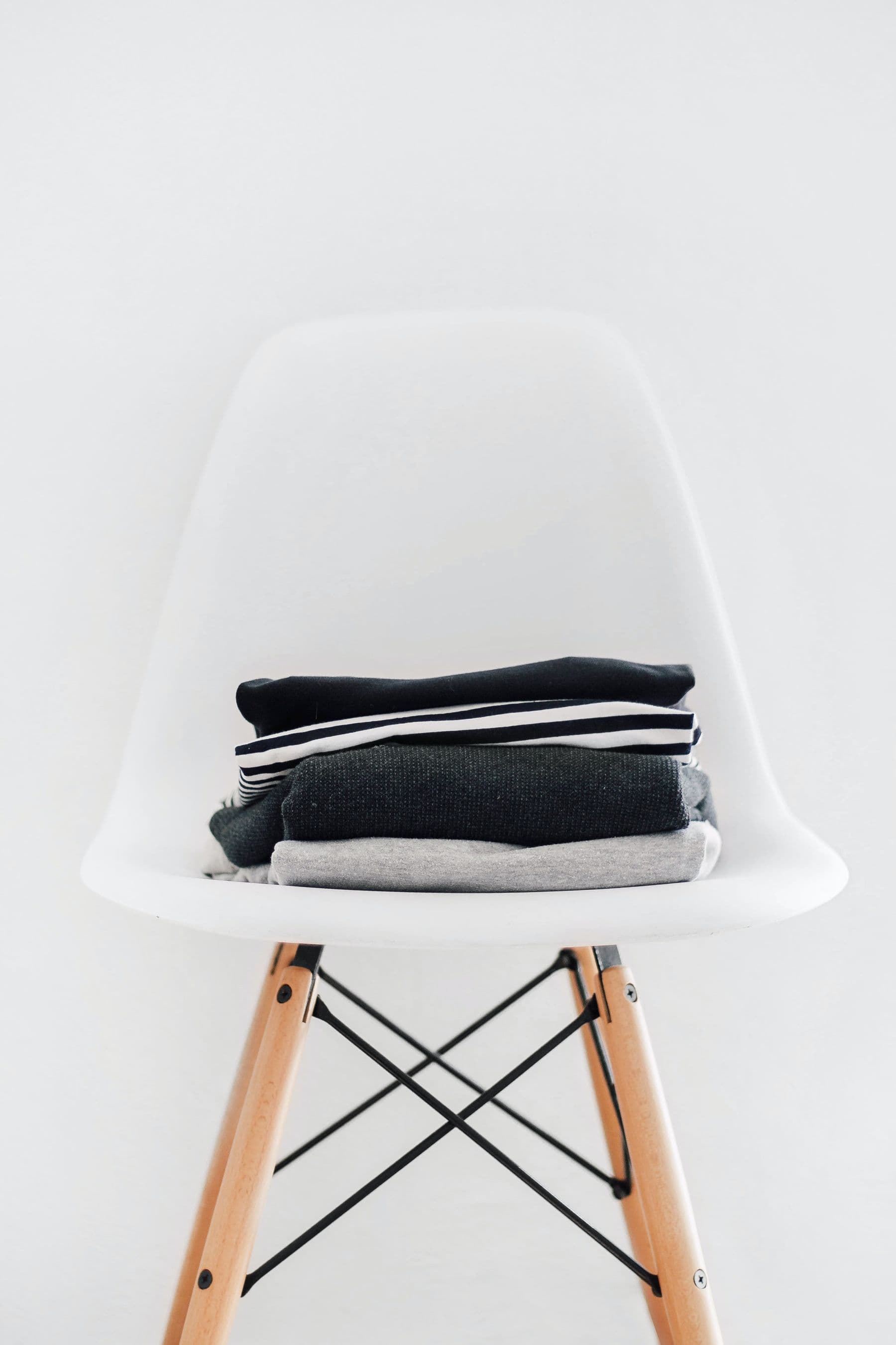 Knitwear folded over the arm of a chair.
